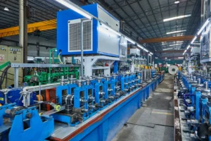 Modern industrial tube mill production line with automated machinery and equipment in a large factory setting