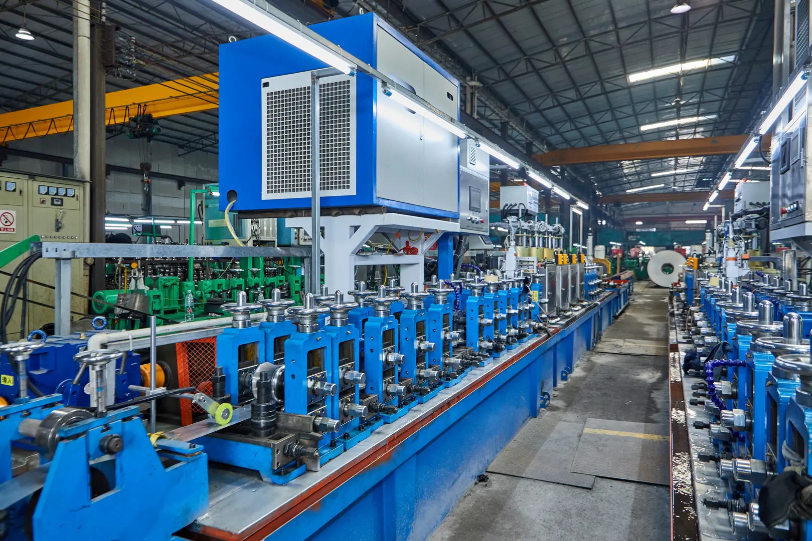 Modern industrial tube mill production line with automated machinery and equipment in a large factory setting