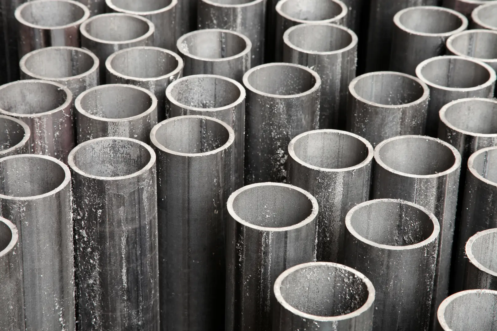 Close-up of neatly arranged industrial steel tubes showcasing their precision and uniformity.