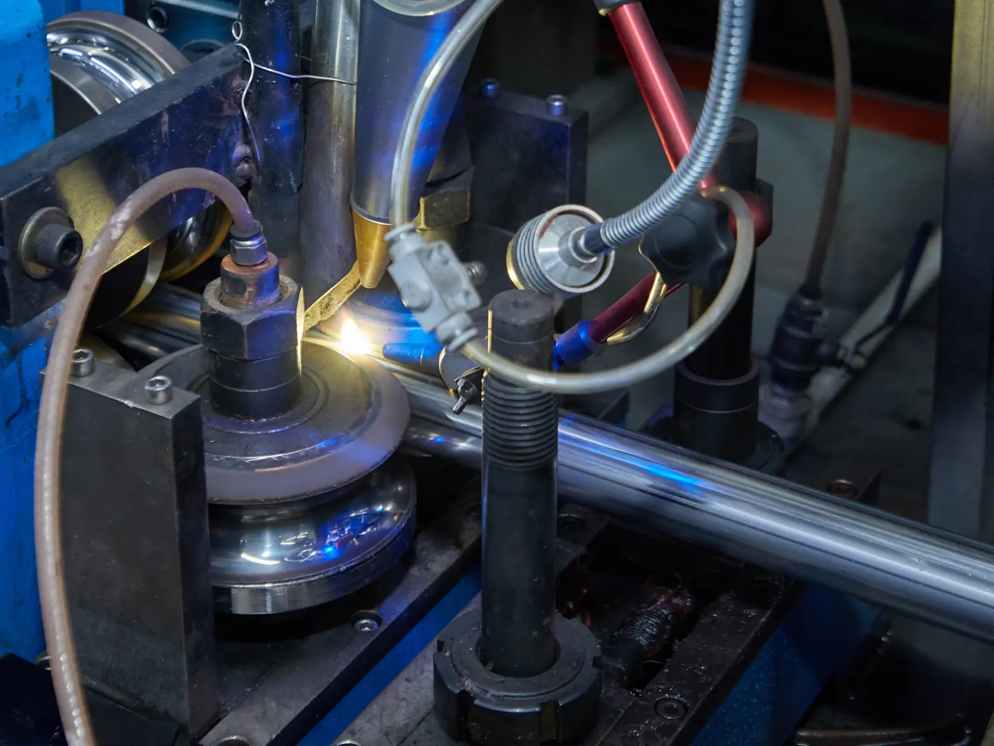 Close-up of precision industrial welding machine with stainless steel tube